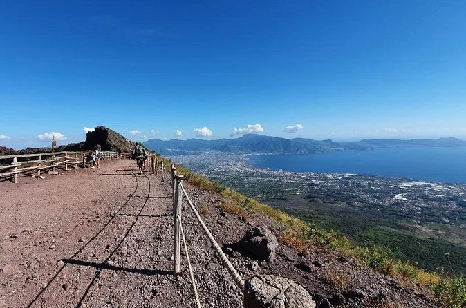 The fenced gravel path on Vesuvius with the Bay of Naples below